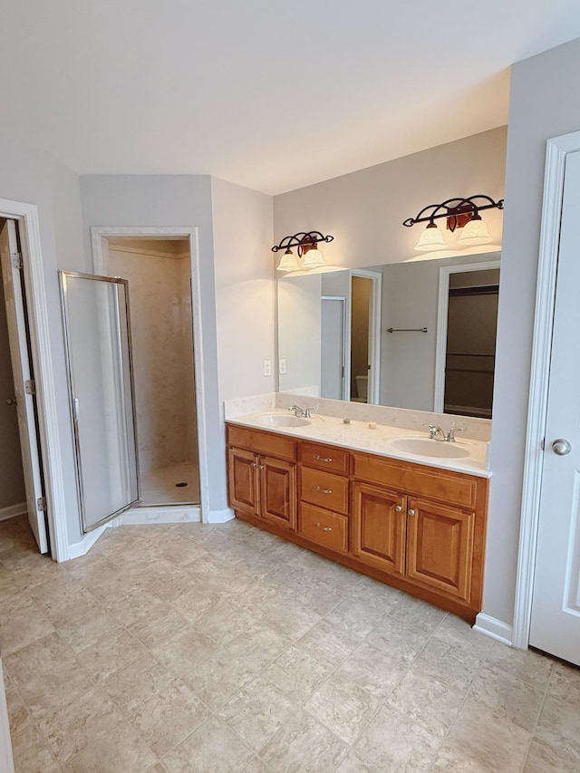 996 Iron Hill Rd, Burns, TN 37029 - bathroom featuring double vanity, a sink, baseboards, and a shower stall