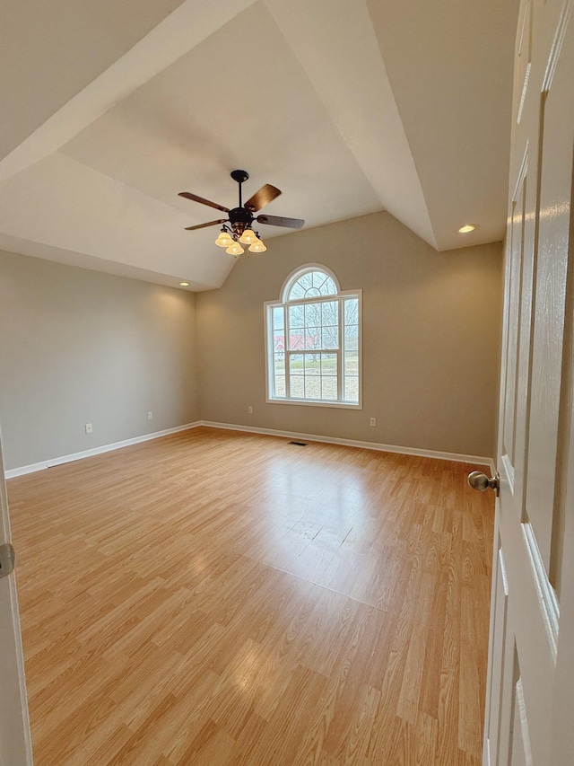 996 Iron Hill Rd, Burns, TN 37029 - empty room with baseboards, light wood-type flooring, a ceiling fan, and vaulted ceiling