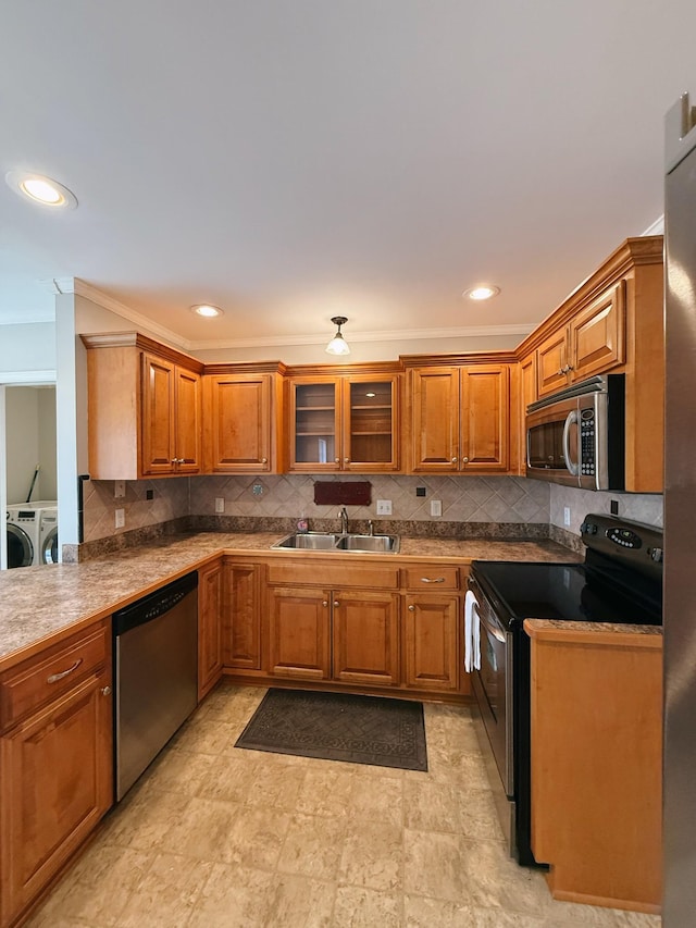 996 Iron Hill Rd, Burns, TN 37029 - kitchen featuring a sink, brown cabinetry, washing machine and clothes dryer, and appliances with stainless steel finishes