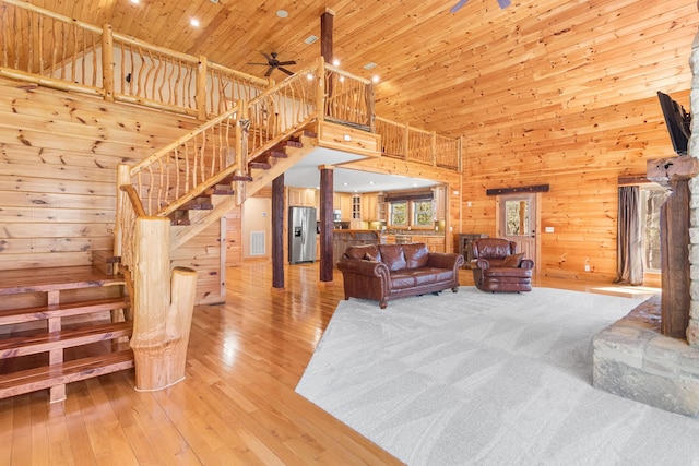 12112 Paw Paw Springs Rd, Arrington, TN 37014 - living room with stairs, light wood-type flooring, wood walls, and wood ceiling