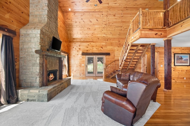 12112 Paw Paw Springs Rd, Arrington, TN 37014 - living area with stairs, a fireplace, a high ceiling, and wood walls