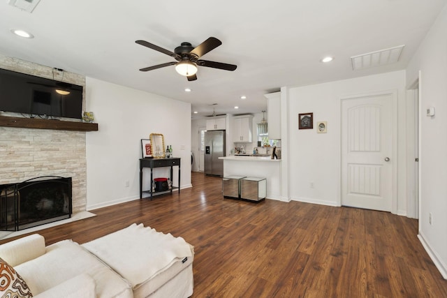 living room featuring ceiling fan, dark wood finished floors, a fireplace, baseboards, and recessed lighting