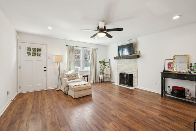 living area with wood finished floors, a ceiling fan, a fireplace, baseboards, and recessed lighting
