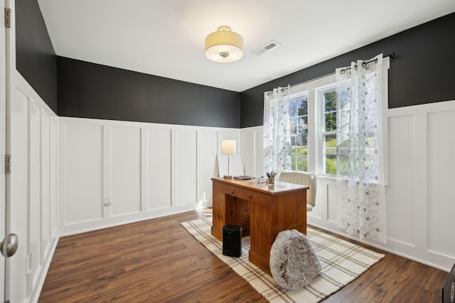 office with a decorative wall, wood finished floors, and wainscoting