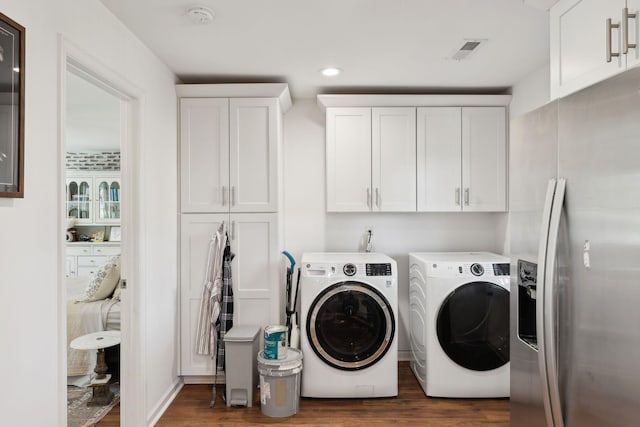 laundry area with washer and clothes dryer, dark wood-type flooring, cabinet space, and recessed lighting