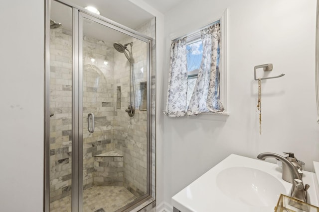 full bath with a shower stall and a sink