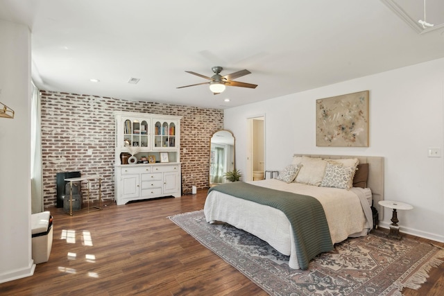 bedroom with dark wood-style flooring, attic access, brick wall, a ceiling fan, and recessed lighting