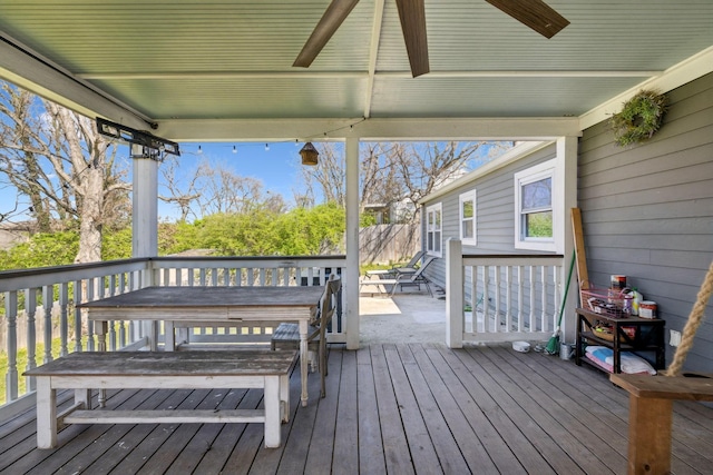 wooden deck with ceiling fan and fence