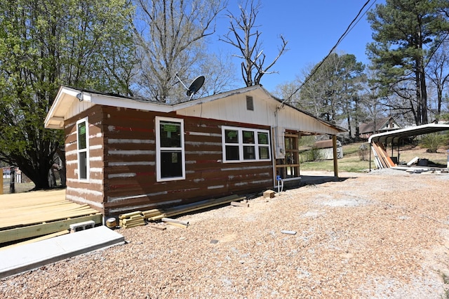 70 Old Bruceton Rd, Bruceton, TN 38317 - view of home's exterior featuring a carport and log siding
