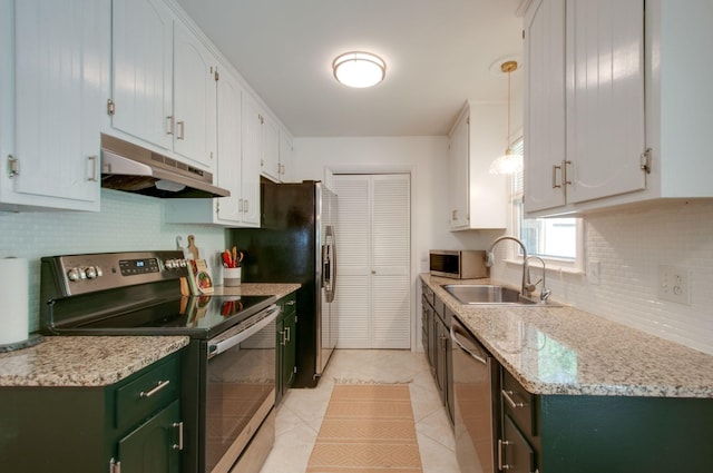 kitchen with stainless steel appliances, under cabinet range hood, decorative backsplash, a sink, and light tile patterned flooring
