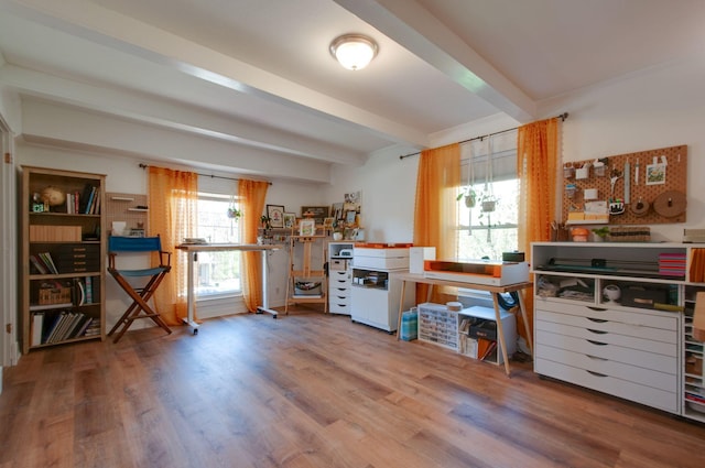 home office with wood finished floors and beam ceiling