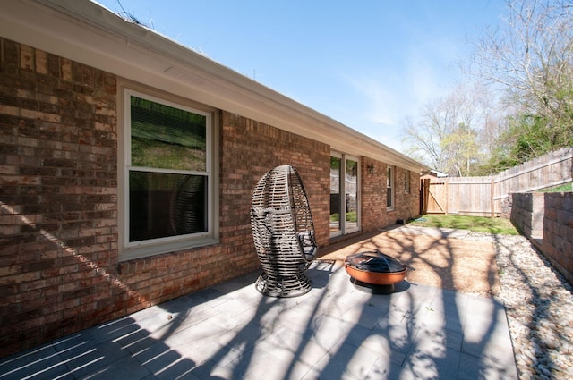 view of patio / terrace featuring an outdoor fire pit and fence