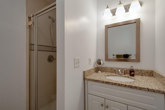 full bathroom with a stall shower and vanity