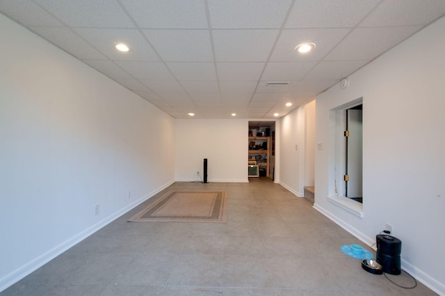 below grade area with a paneled ceiling, baseboards, and recessed lighting