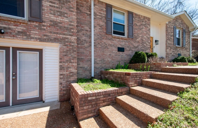 doorway to property featuring brick siding