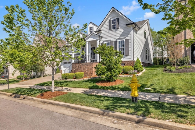view of front of property featuring driveway, a garage, and a front yard