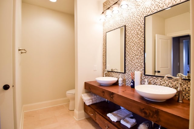 1395 Rozella Way, Gallatin, TN 37066 - full bathroom with baseboards, backsplash, toilet, and a sink