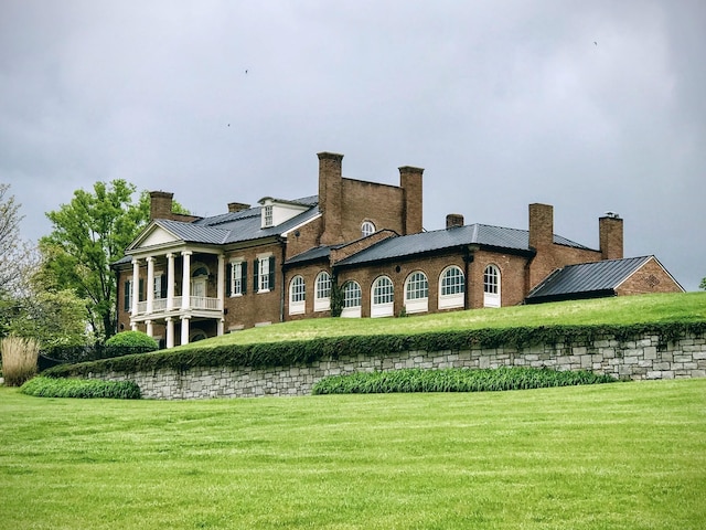 1395 Rozella Way, Gallatin, TN 37066 - rear view of property featuring a chimney, a standing seam roof, metal roof, and a yard