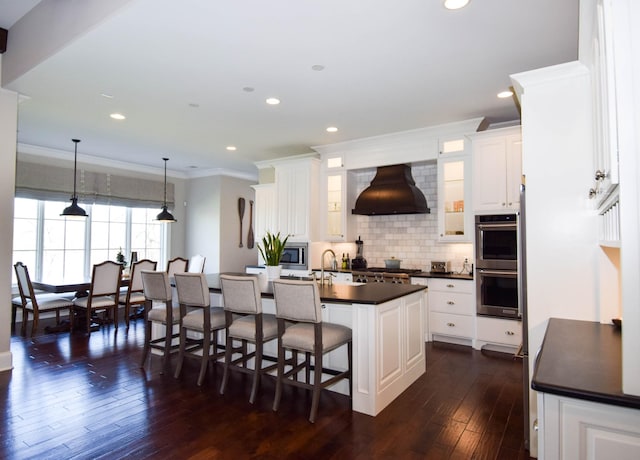 1395 Rozella Way, Gallatin, TN 37066 - kitchen with custom exhaust hood, crown molding, stainless steel appliances, dark countertops, and backsplash