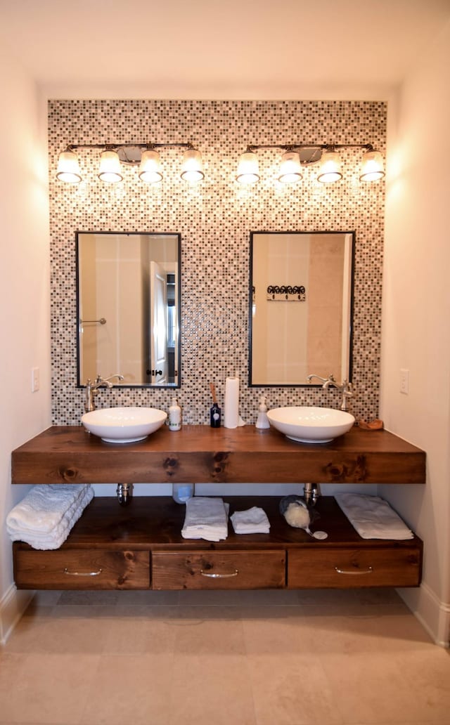 1395 Rozella Way, Gallatin, TN 37066 - full bathroom featuring double vanity, backsplash, baseboards, and a sink