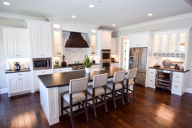 1395 Rozella Way, Gallatin, TN 37066 - kitchen featuring range hood, wine cooler, dark wood-type flooring, dark countertops, and appliances with stainless steel finishes