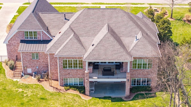 1395 Rozella Way, Gallatin, TN 37066 - rear view of property featuring stairs, brick siding, and a lawn