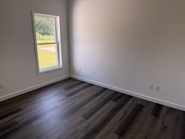 7022 Magnolia Ln, Nunnelly, TN 37137 - spare room with baseboards and dark wood-style flooring