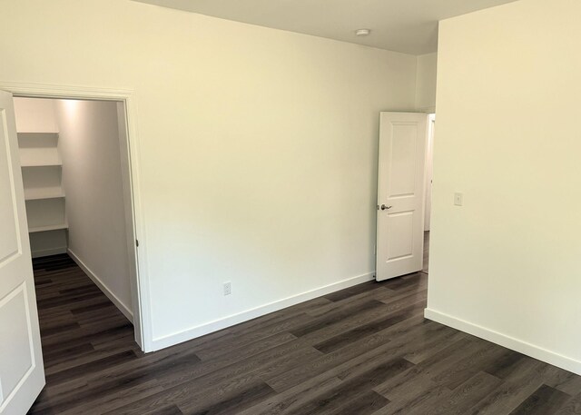 7022 Magnolia Ln, Nunnelly, TN 37137 - spare room featuring dark wood-type flooring and baseboards