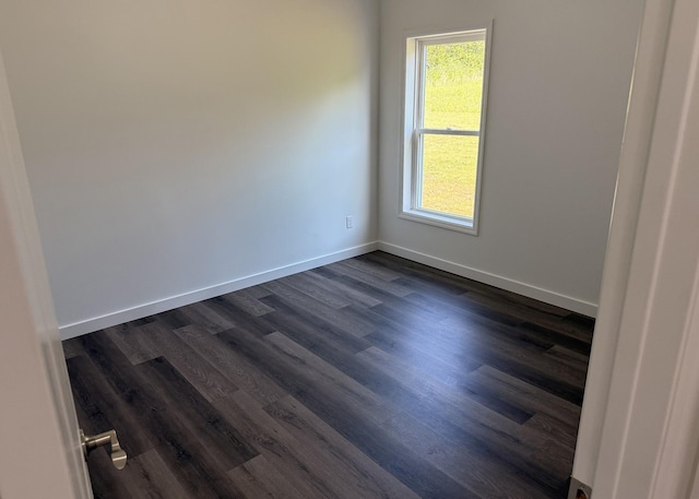 7022 Magnolia Ln, Nunnelly, TN 37137 - spare room featuring dark wood-type flooring and baseboards