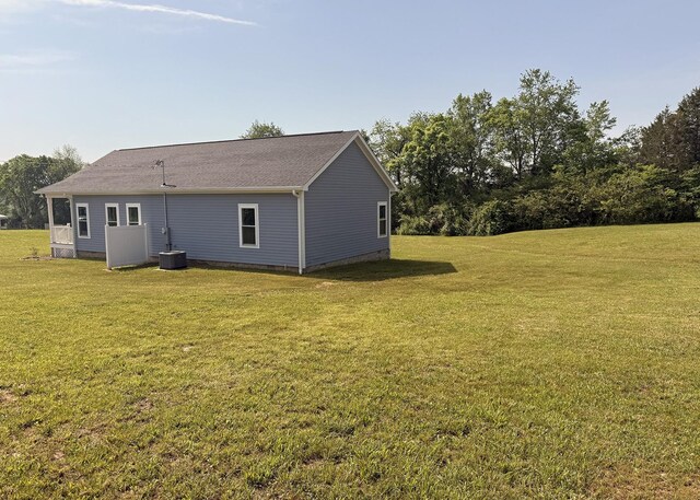 7022 Magnolia Ln, Nunnelly, TN 37137 - back of property featuring a lawn, crawl space, and central AC
