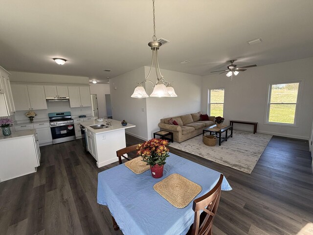 7022 Magnolia Ln, Nunnelly, TN 37137 - dining area with dark wood finished floors, a ceiling fan, and baseboards