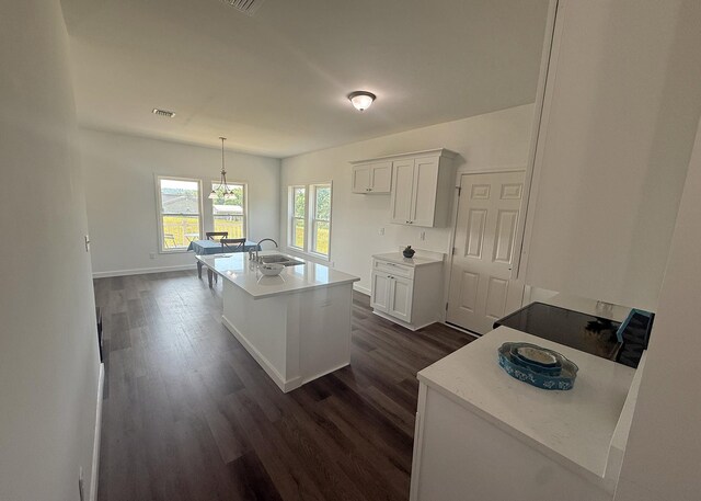 7022 Magnolia Ln, Nunnelly, TN 37137 - kitchen with dark wood finished floors, white cabinets, a center island with sink, and light countertops