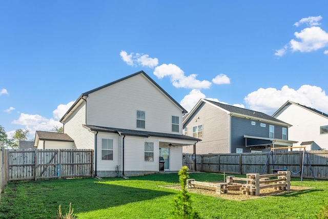 back of property featuring a fenced backyard, a lawn, and a vegetable garden
