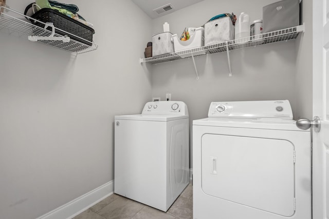 washroom with separate washer and dryer, baseboards, laundry area, and visible vents