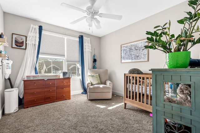 bedroom with baseboards, carpet flooring, a ceiling fan, and a nursery area