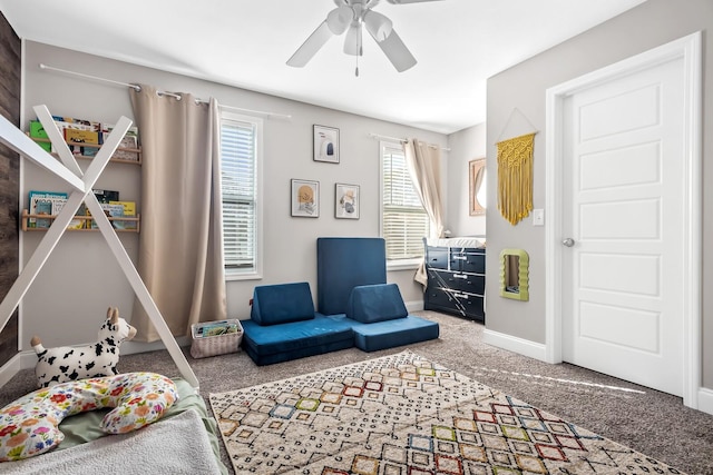carpeted bedroom featuring baseboards and ceiling fan