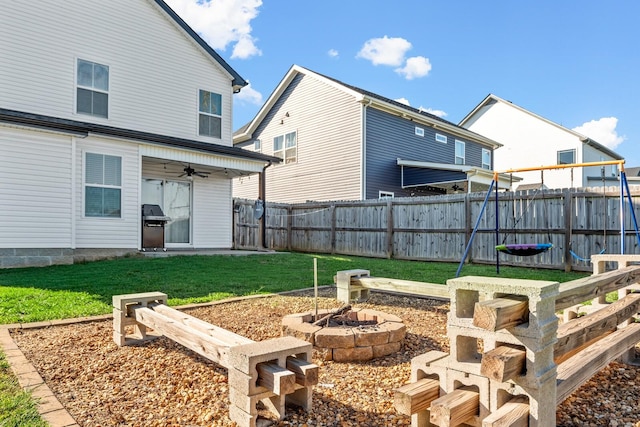view of yard with an outdoor fire pit and fence