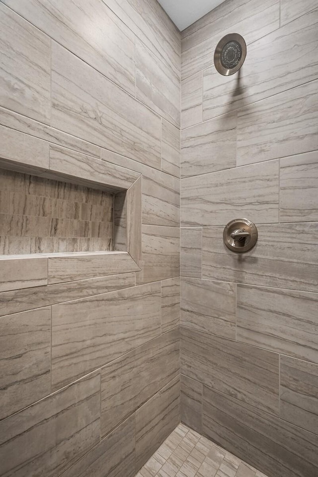 bathroom with tiled shower