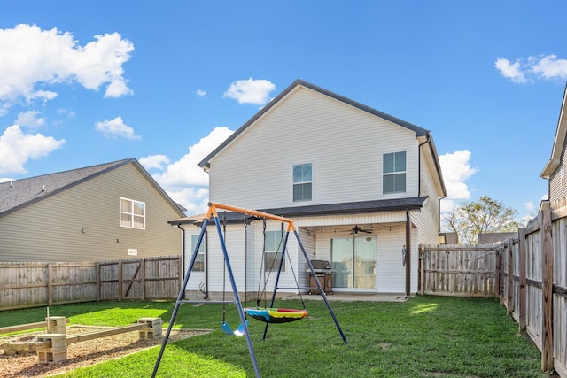 back of house featuring a patio, ceiling fan, a fenced backyard, and a yard