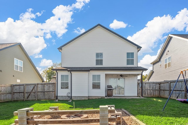 back of house featuring a fenced backyard, a ceiling fan, a gate, and a yard
