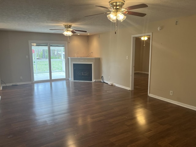 unfurnished living room with a ceiling fan, wood finished floors, baseboards, and a textured ceiling