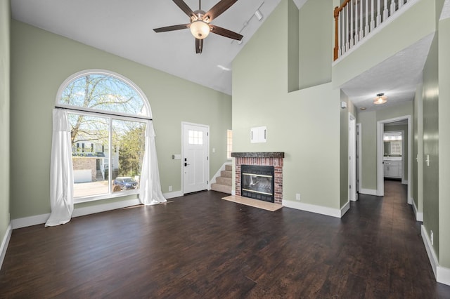 1829 Apple Valley Cir, Nashville, TN 37207 - unfurnished living room featuring stairway, baseboards, ceiling fan, a brick fireplace, and wood finished floors