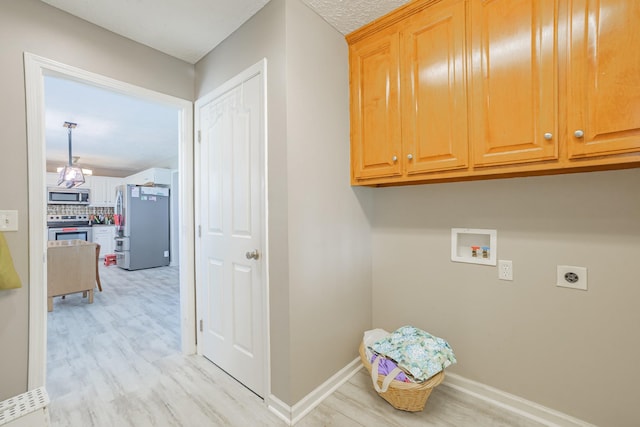 laundry area with baseboards, light wood-style floors, hookup for an electric dryer, cabinet space, and hookup for a washing machine