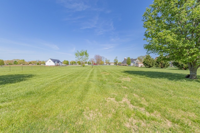 view of yard with a rural view and fence