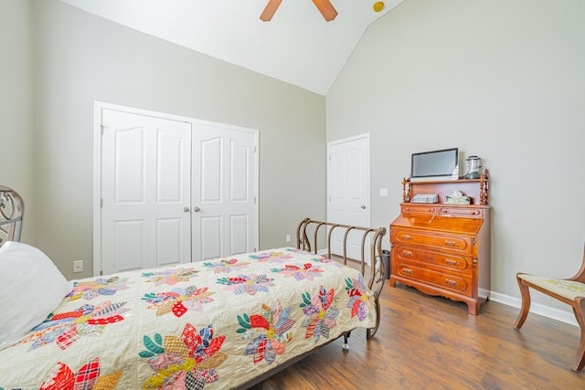 bedroom with high vaulted ceiling, a closet, a ceiling fan, wood finished floors, and baseboards