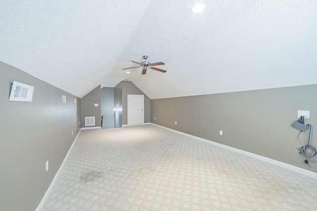 bonus room featuring a textured ceiling, ceiling fan, baseboards, and visible vents