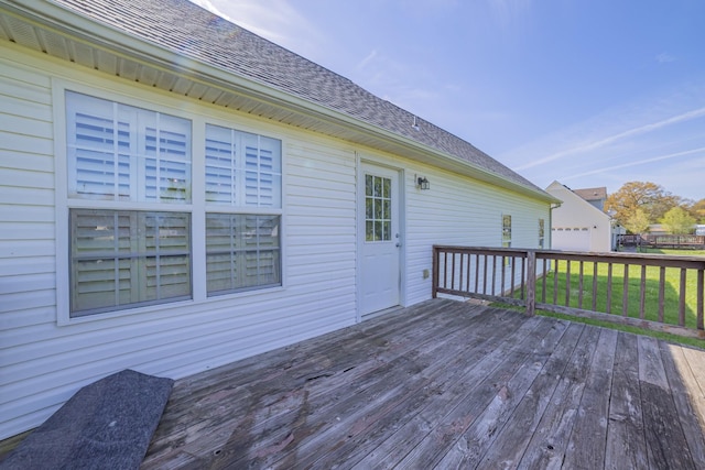 wooden deck featuring a yard