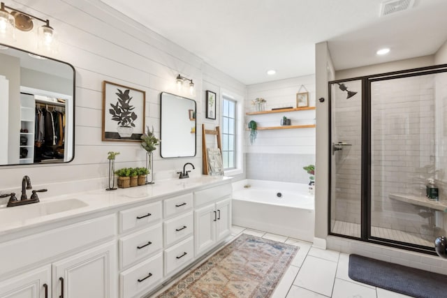 bathroom with a shower stall, visible vents, tile patterned flooring, and a sink