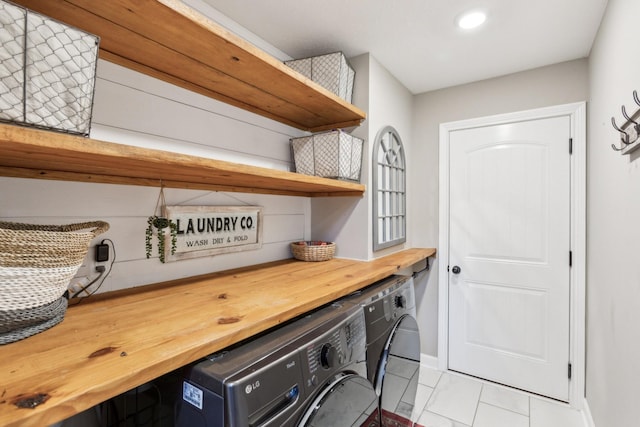clothes washing area with recessed lighting, baseboards, washer and dryer, and laundry area