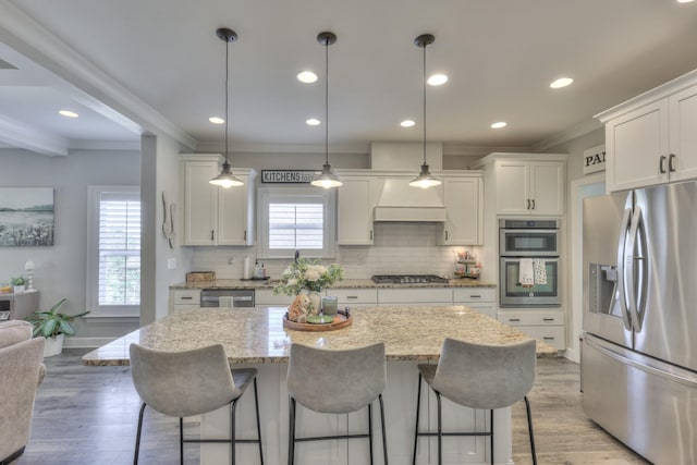 127 Waters Hill Cir, Lebanon, TN 37087 - kitchen with white cabinetry, appliances with stainless steel finishes, custom exhaust hood, and decorative backsplash